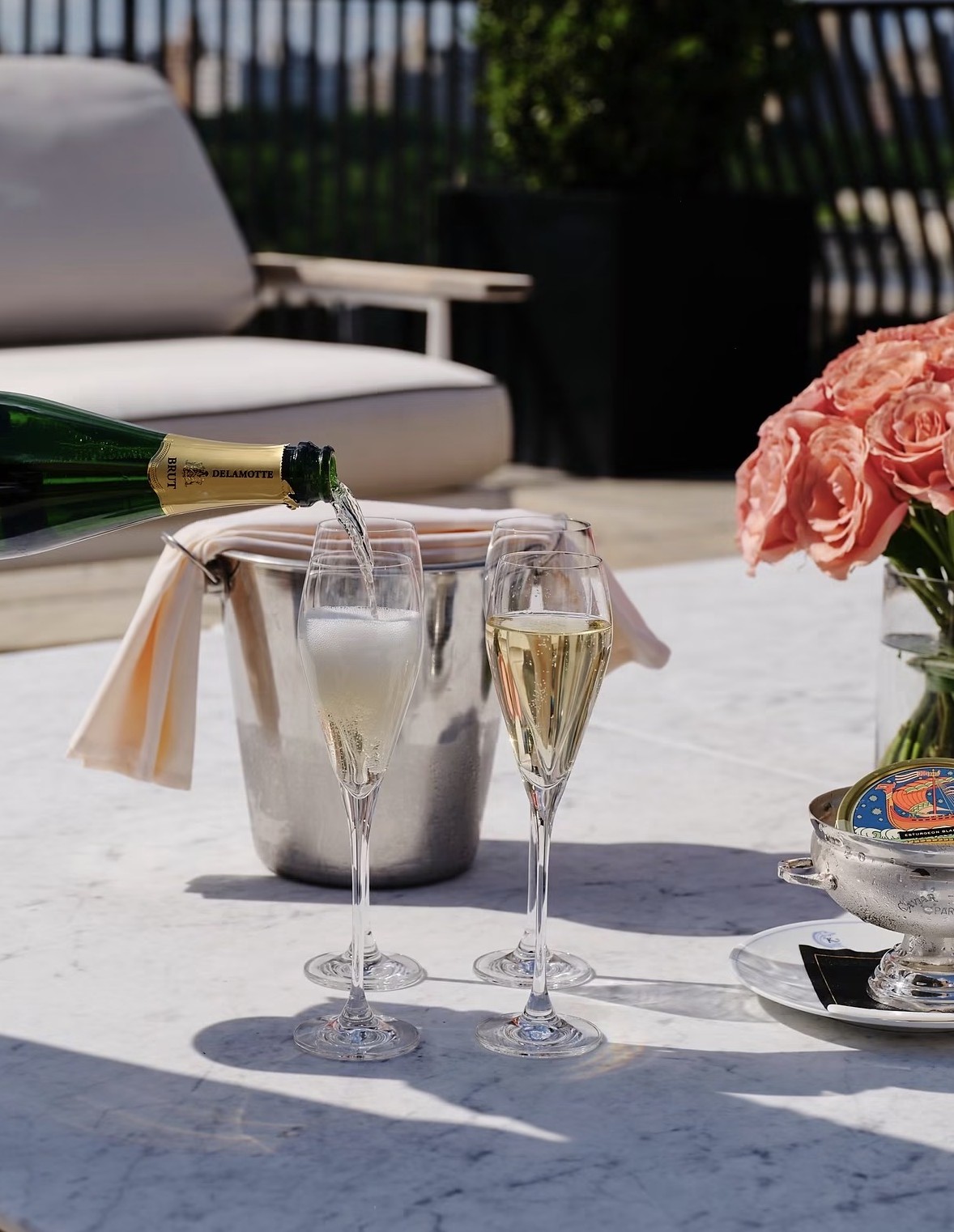 Champagne poured on a sunlit terrace