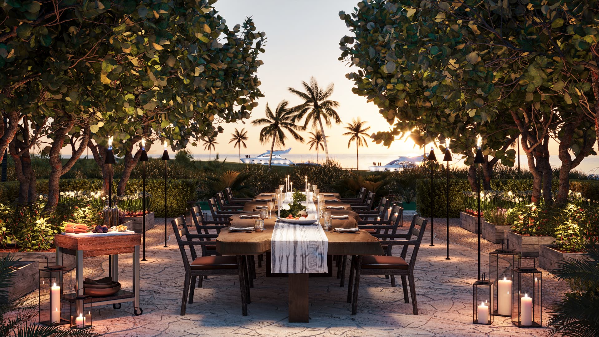 Long dinner table lit by candles at dusk