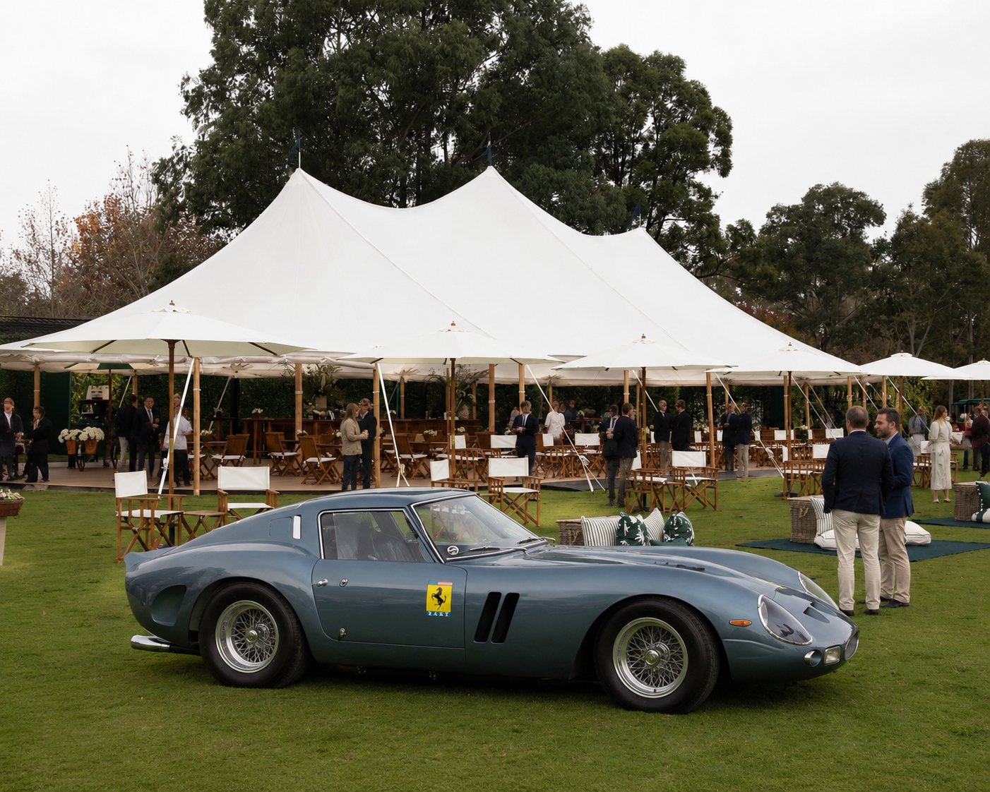 Classic grand touring car on the lawn before white marquees